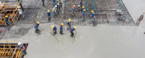 Concrete floor slab placement and finishing
