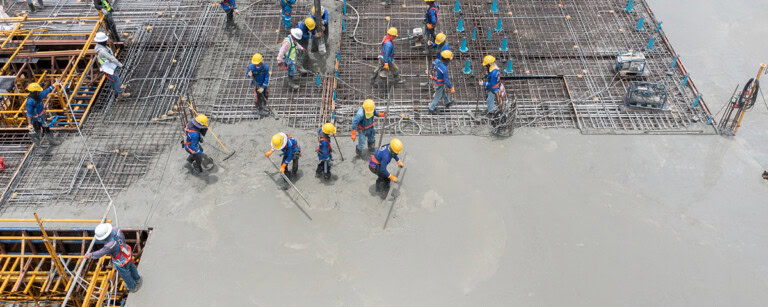 Concrete floor slab placement and finishing