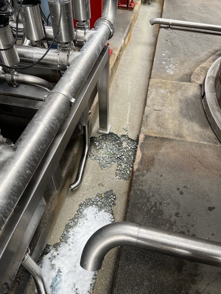 Acid attack on concrete drain in dairy production facility
