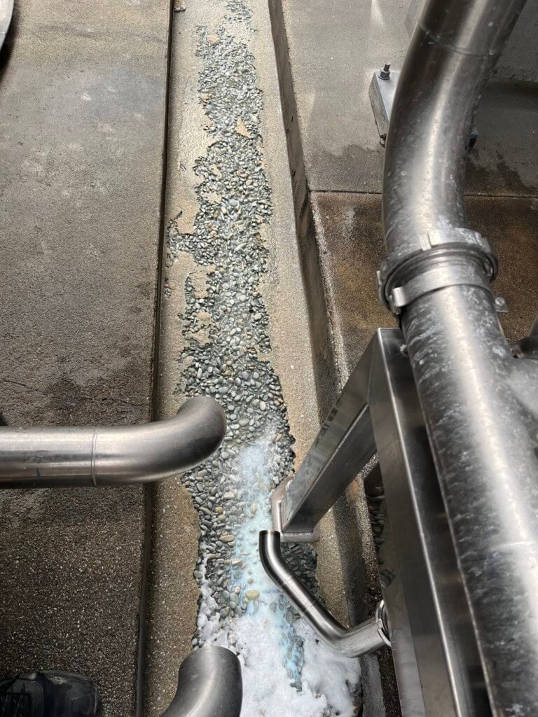 Acid attack on concrete drain in dairy production facility