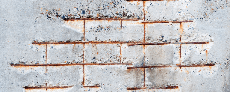 Concrete with low cover issues visible corroding reinforcement steel