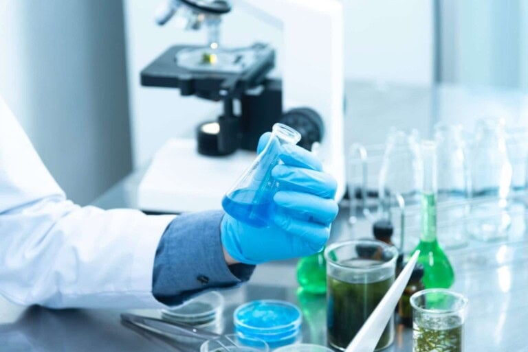 person-holding-laboratory-flask-2280571-scaled-1